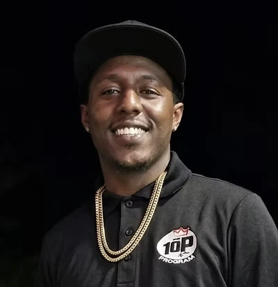 Portrait of Eric Abercrombie smiling in a black 10P Program shirt