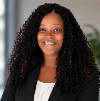 Portrait of Nicole Brown smiling, wearing a black blazer
